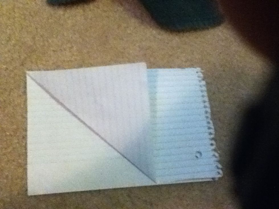 then take the corner of the paper and align it with the straight edge on the other side