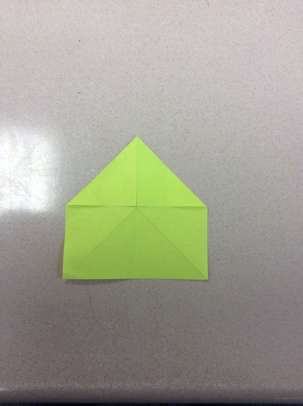 Then, take the left top corner and fold it to the center. It should look like a house.