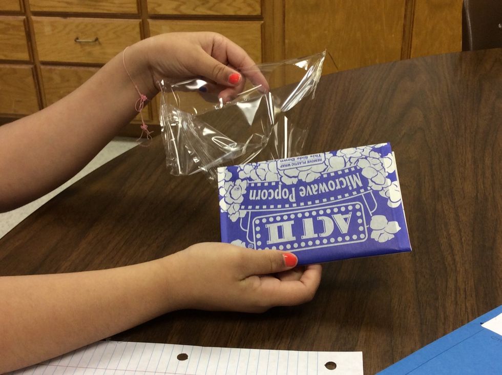 Then take the plastic off the popcorn bag.