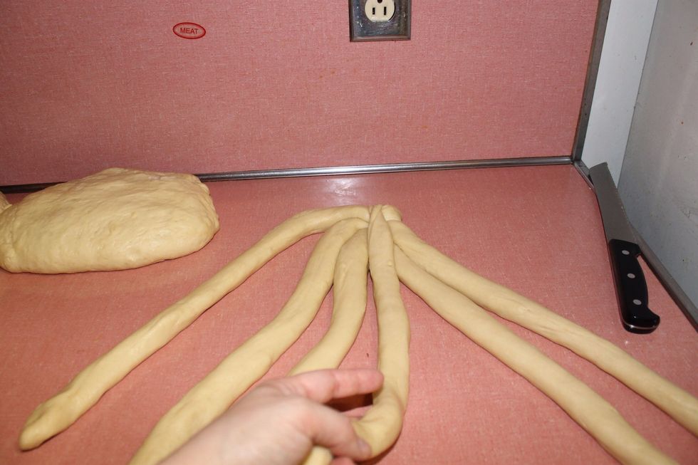 Then take the right outermost strand and place it in the middle of the 4 innermost stands