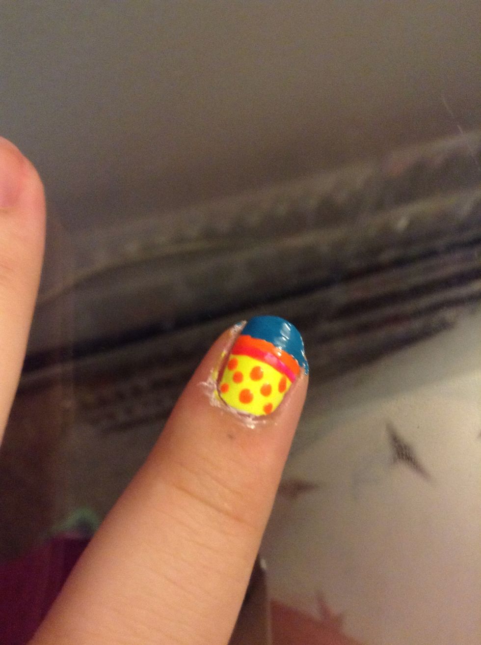 Then take the same color you did your second thin line in, orange for me, and dot on to your first color, yellow for me.