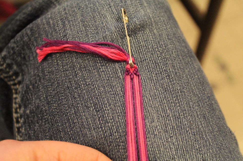 Then take the second string in on the right and tie it around the outside string on the right using the foreword knot going right.