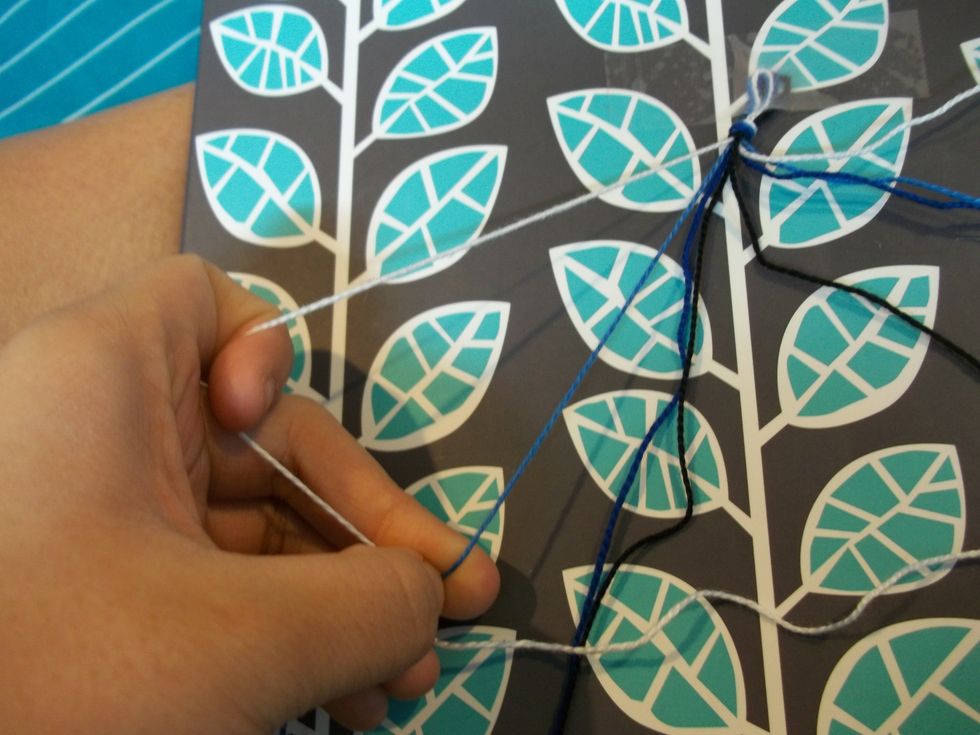 Then take the string next to it and make a 4 with the strings.