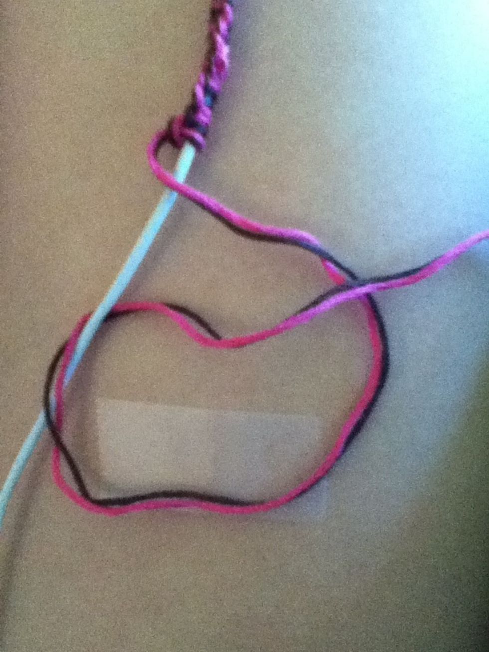 Then take the tail on the end and pull under the earbud cord and over the thread to form a knot