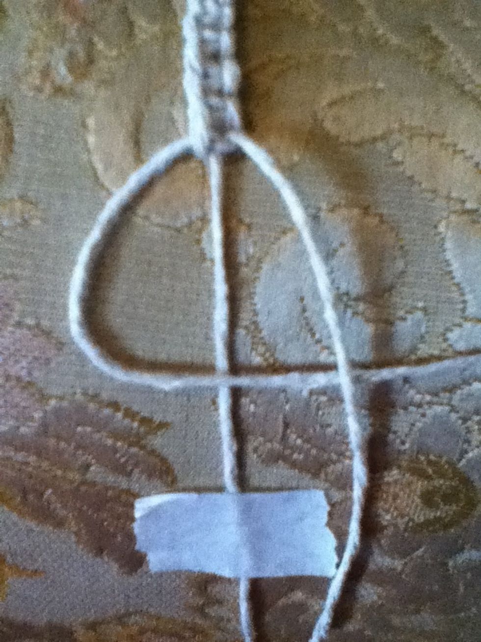 Then take the thread on the right and lay it over the left one