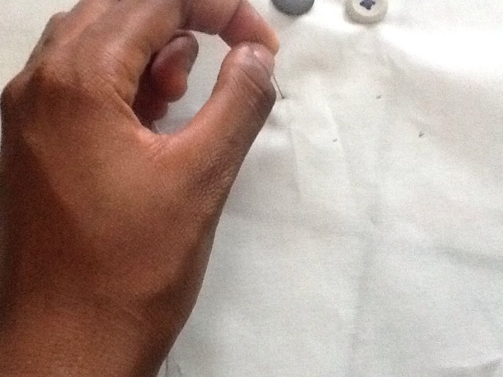 Then take your fabric and punch a hole through it with your needle