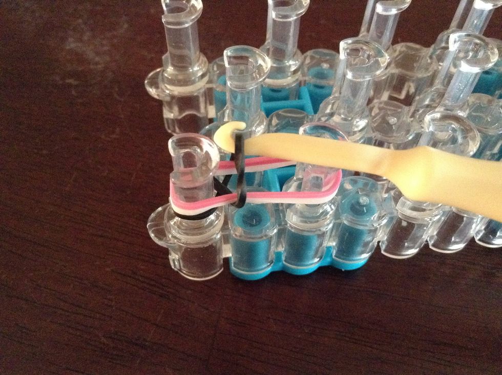 Then take your hook and take the bottom rubber band which was the 8 and put it over the 2 rubber bands