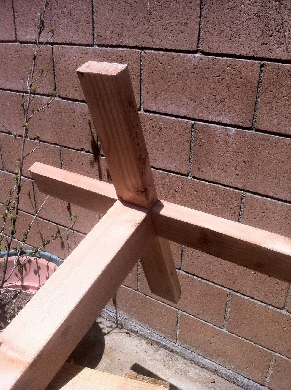 Then the 2x4 that was cut at 1 feet each, connect them to each side of the 4x4 as the base so your stand will stand on its own.
