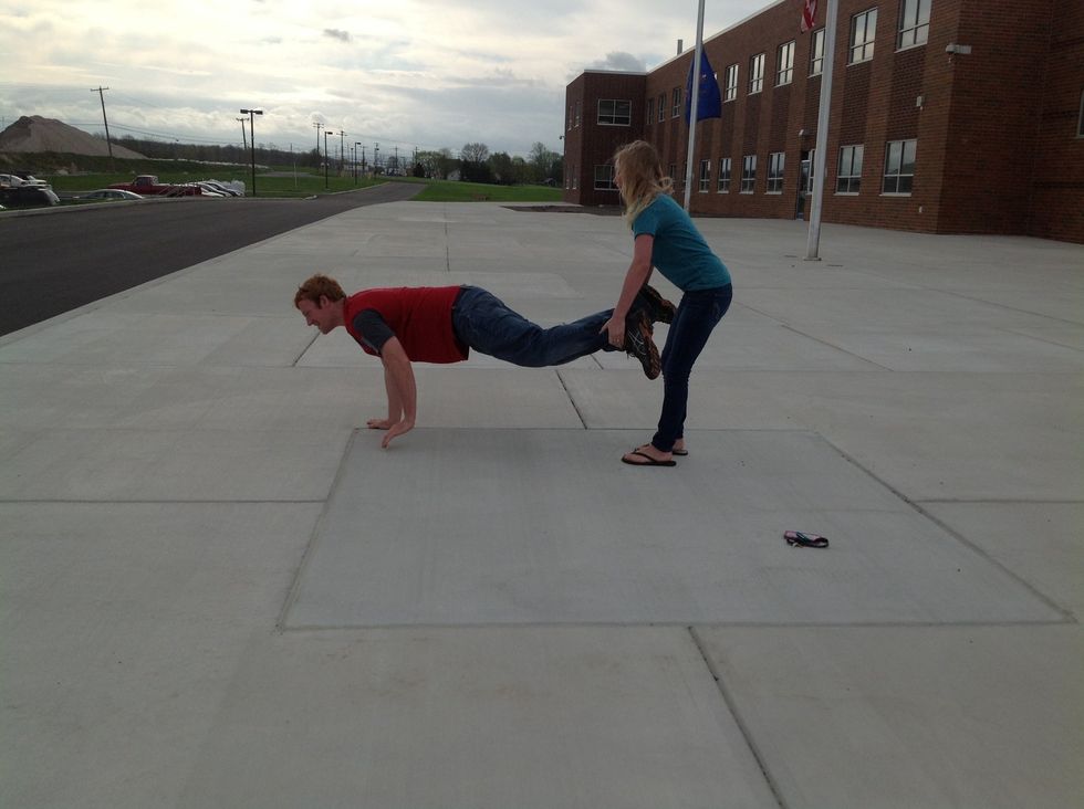 Then the person behind, holding the feet, puts the feet on the ground.