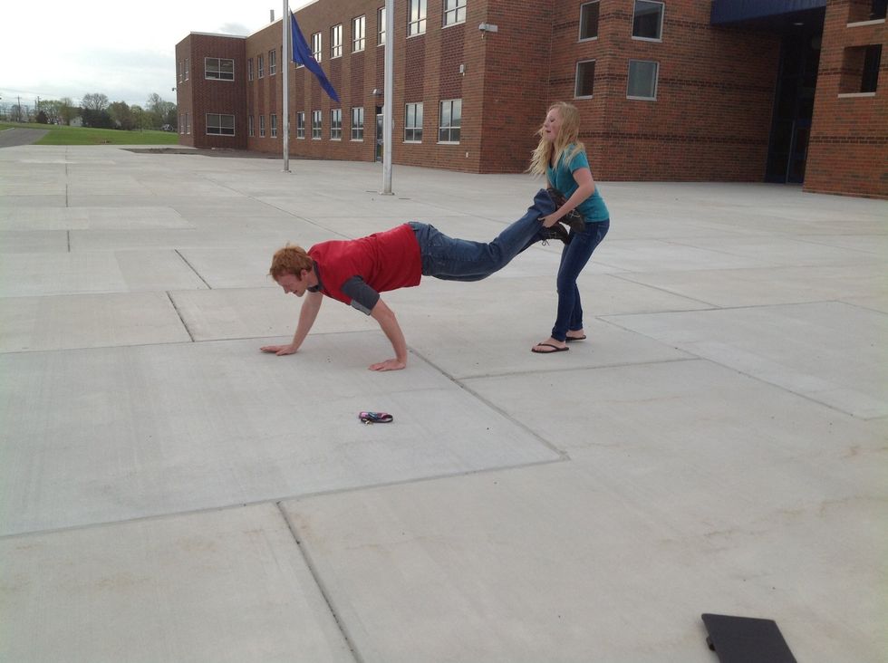 Then, the person on the ground gives the person behind them, their other foot.