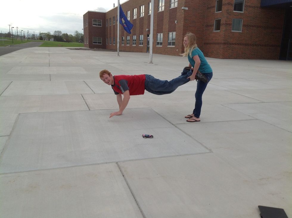 Then, the person on the ground walks on their hands to make a wheel barrel.