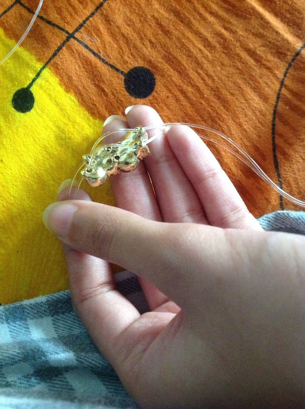 Then thread the elastic through the holes. In this manner put all of them. Enough to wrap around your wrist.