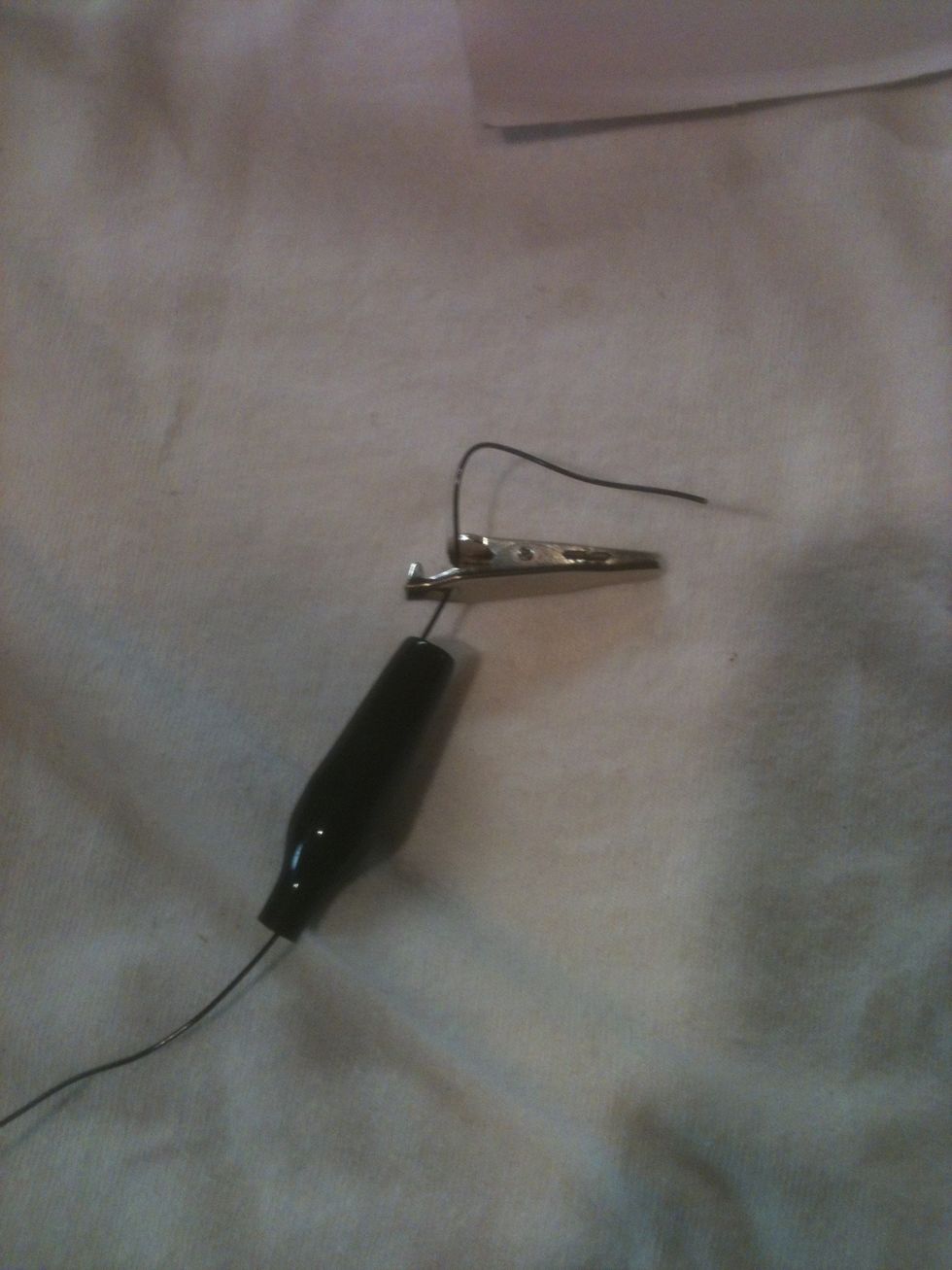 Then thread your wire through the insulator, and through the hole at the base of the clip.