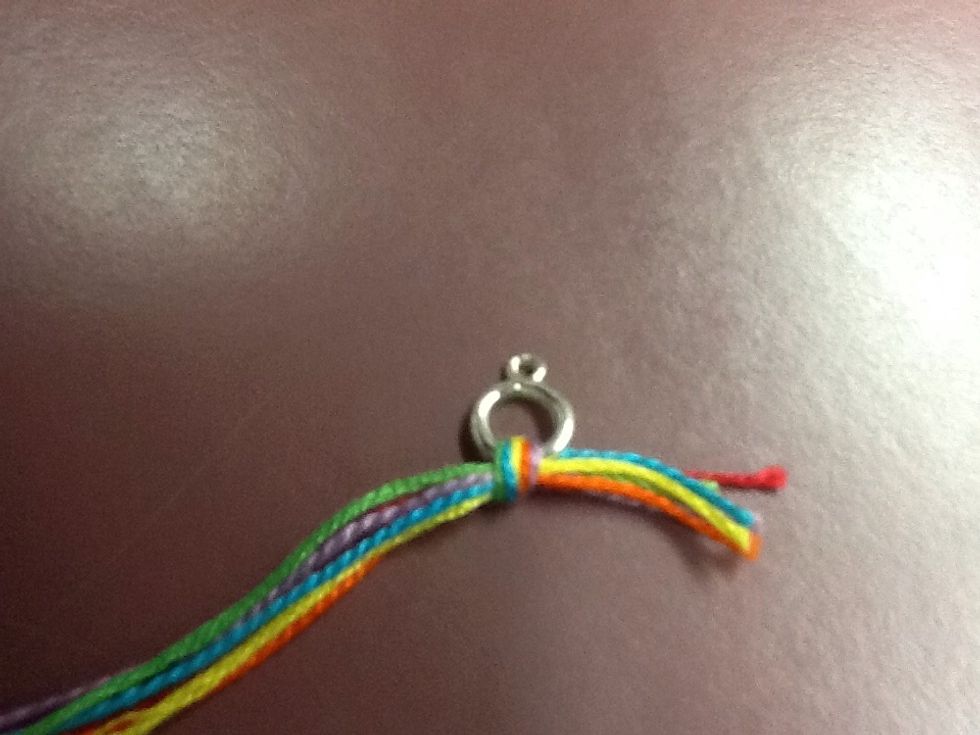 Then tie the thread in a knot through a ring.