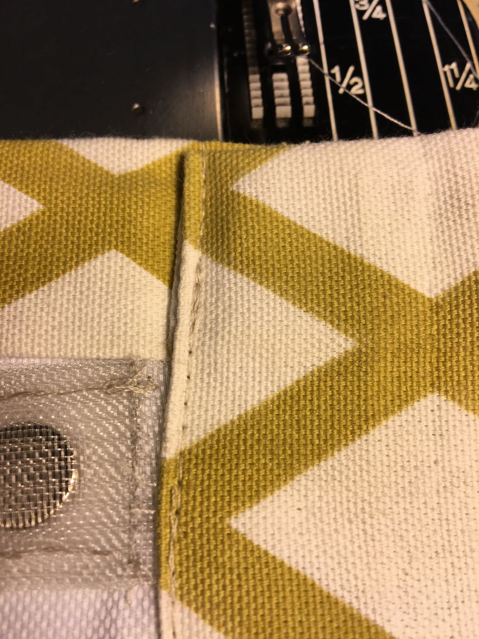 Then top stitch the bottom hem as close to the edge as possible catching the magnet tape but not the magnet pocket as shown