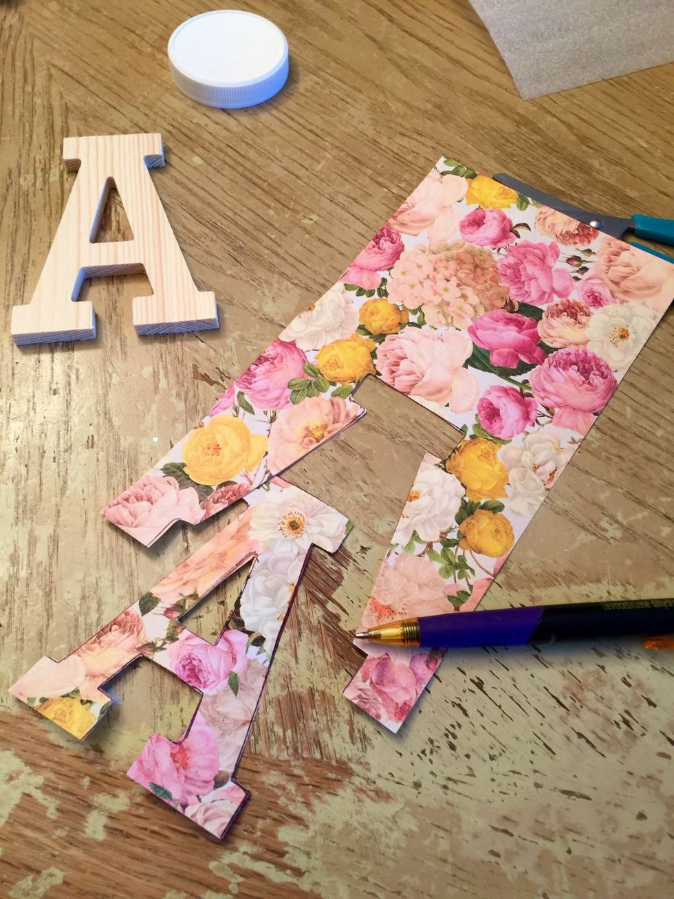 Then trace the wooden letters on the paper.