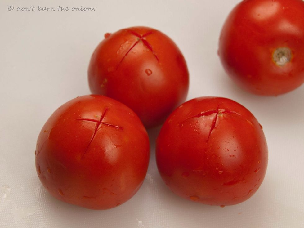 Then turn them upside down and use your knife to make a large cross in the skin.