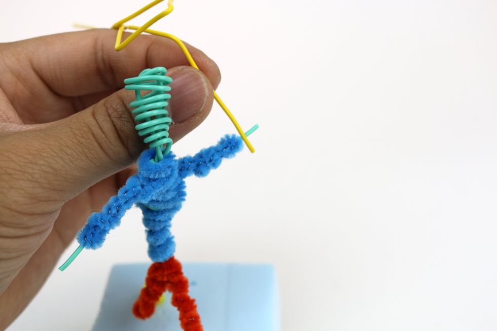 Then twist the kite rope around one of the hands of your figure.