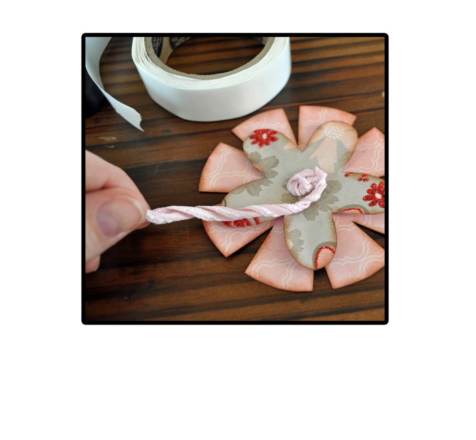 Then twist your ribbon and use more glue dots/glue gun to continue adhering the ribbon in a circular pattern.