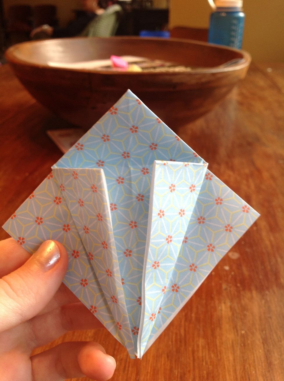 Then unfold and fold the top corners forward