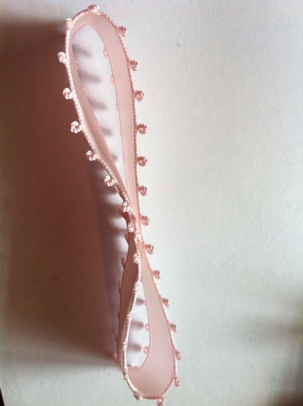 Then use the glue gun to glue the strip in this way: fold the two ends into the middle part of the strip.