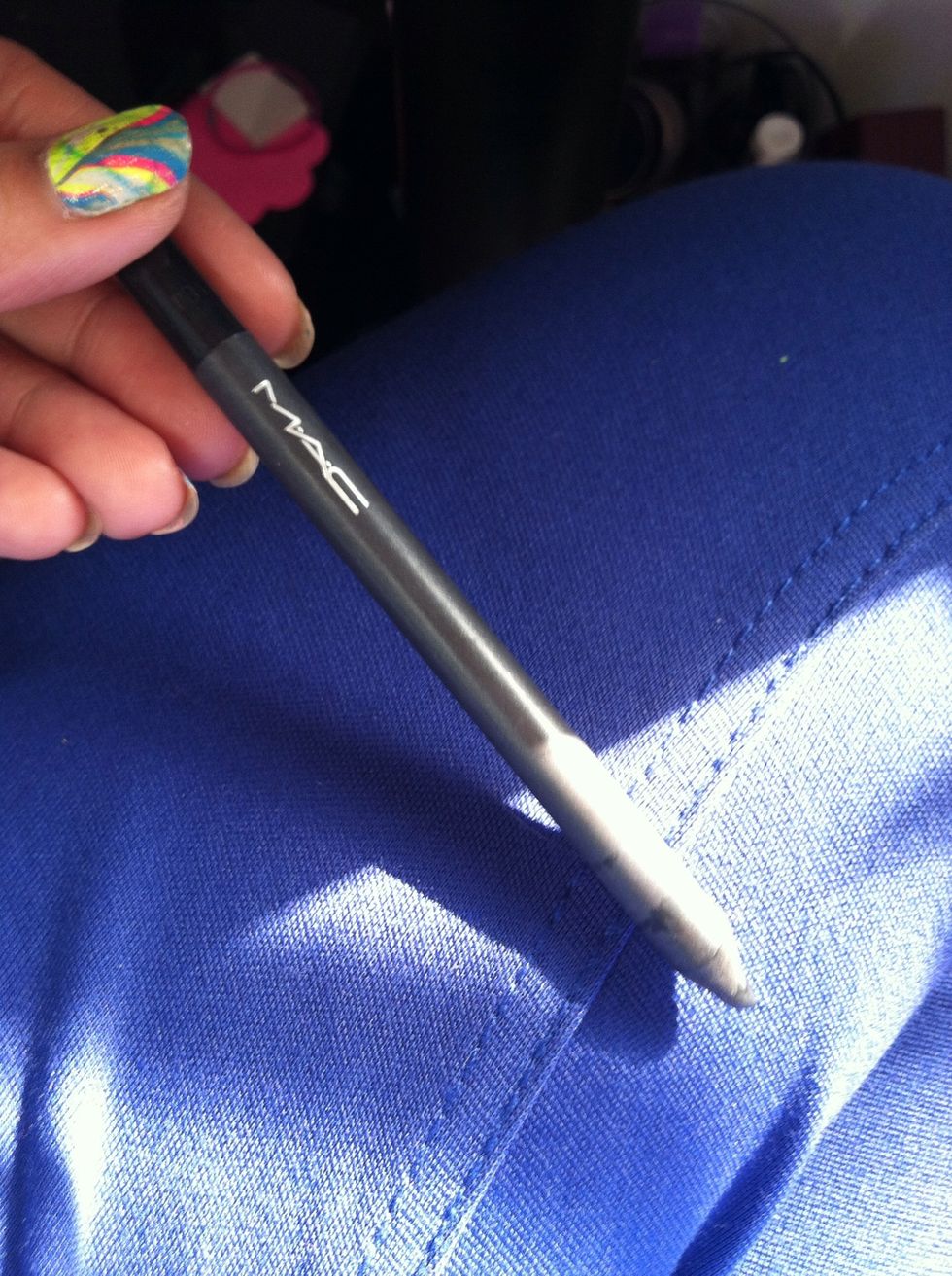 Then use your black eyeliner to make triangles on both your lower and upper lips.