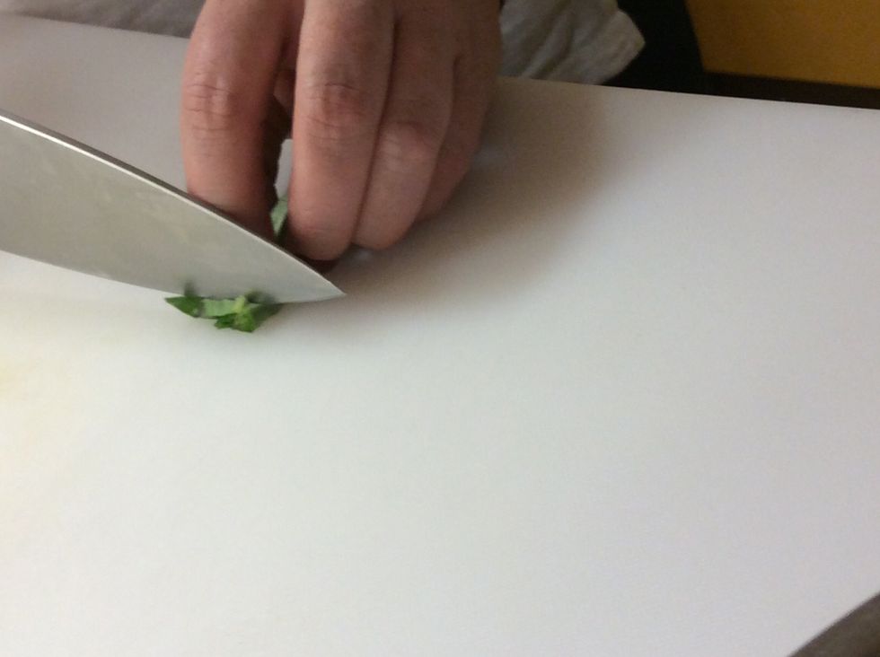 Then using a chefs knife, slice the rolled leaves as thinly as possible.