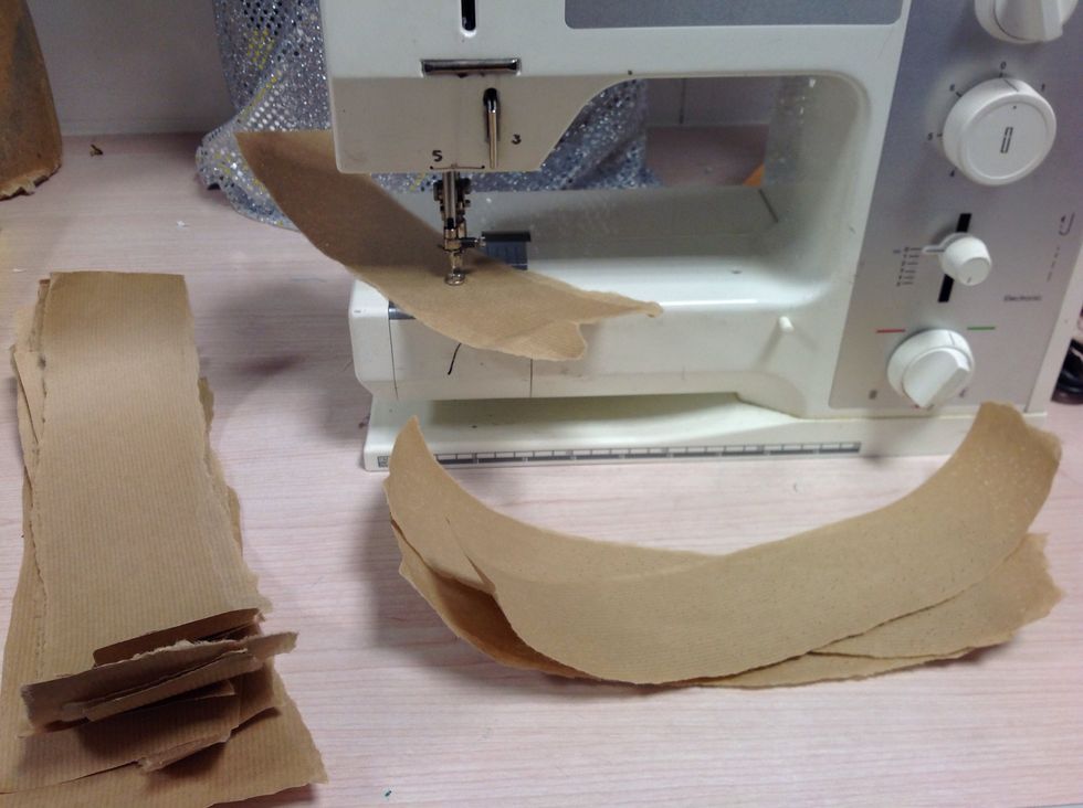 Then using an unthreaded sewing machine on a free hand setting; sew into the paper to create small holes giving the bark a wood worm effect