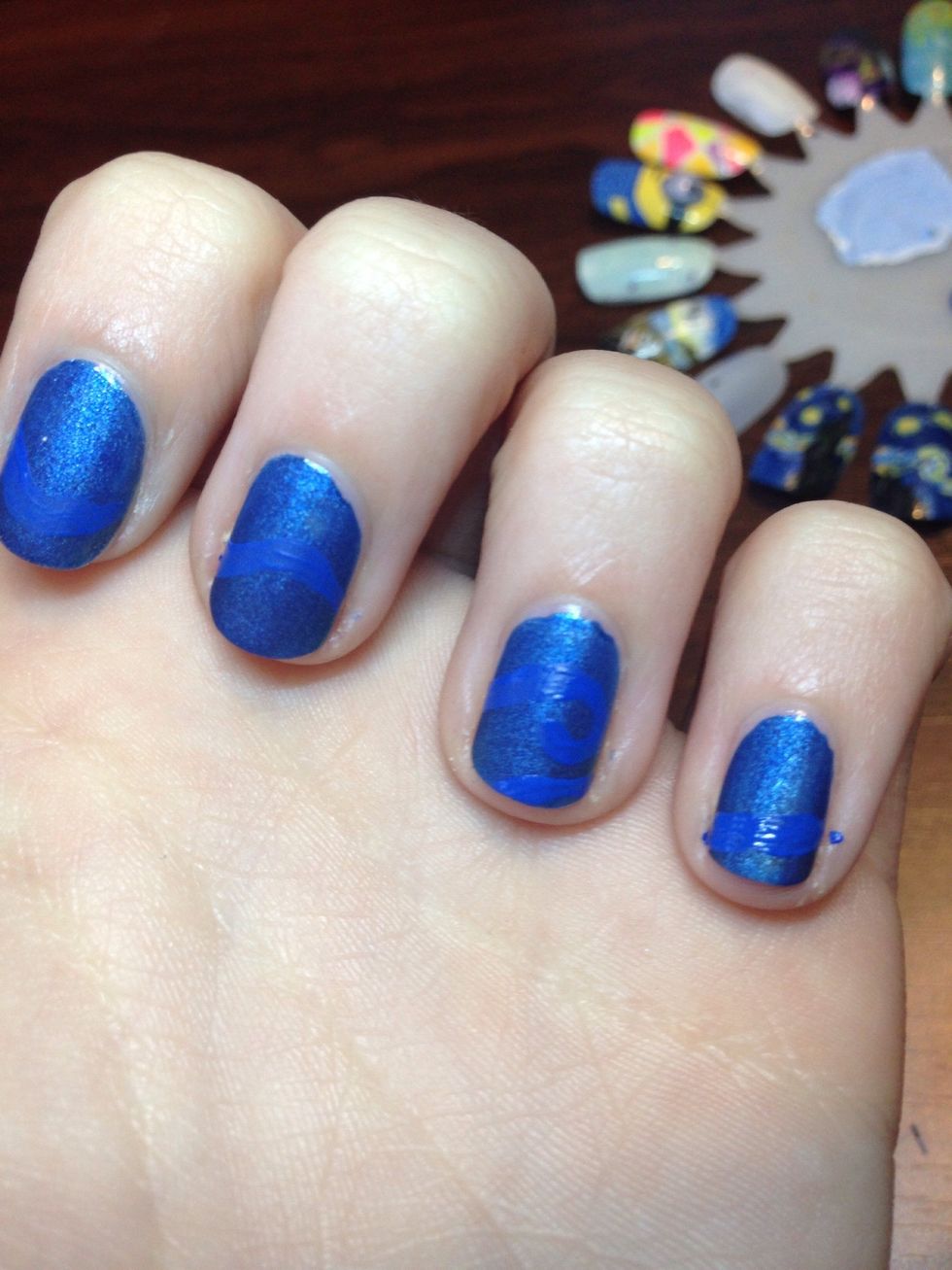 Then using blue acrylic paint, I paint wavy lines across all four nails (making it look like they connect)