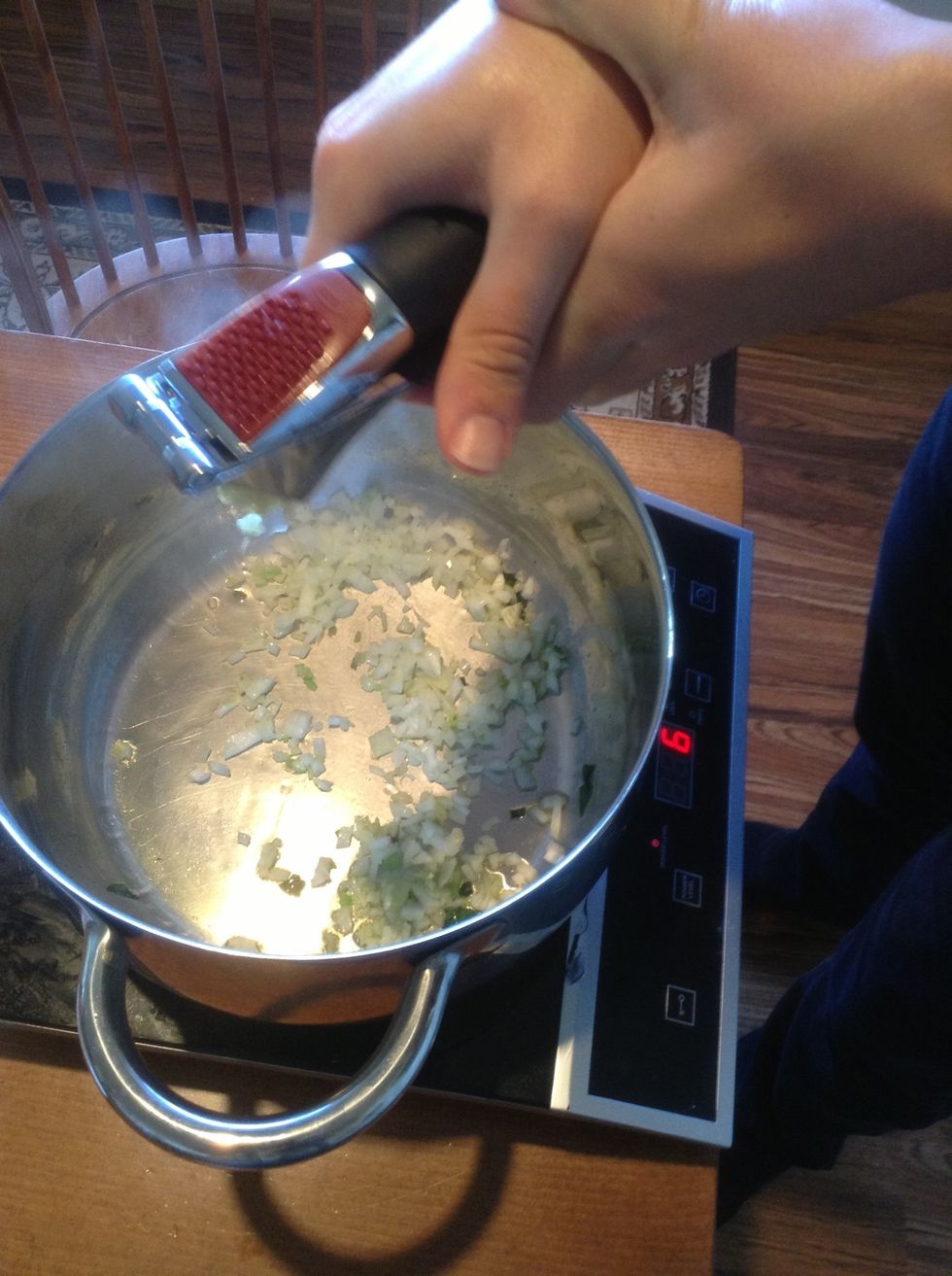 Then using garlic press over the skillet. Put one clove at a time in press and squeeze  the handles together.