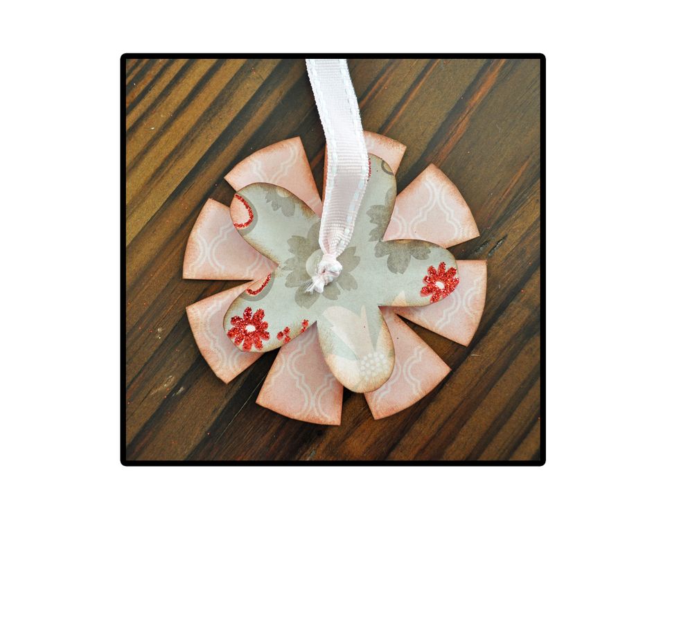Then, using glue dots or a hot glue gun, adhere the ribbon to the center of your flower.