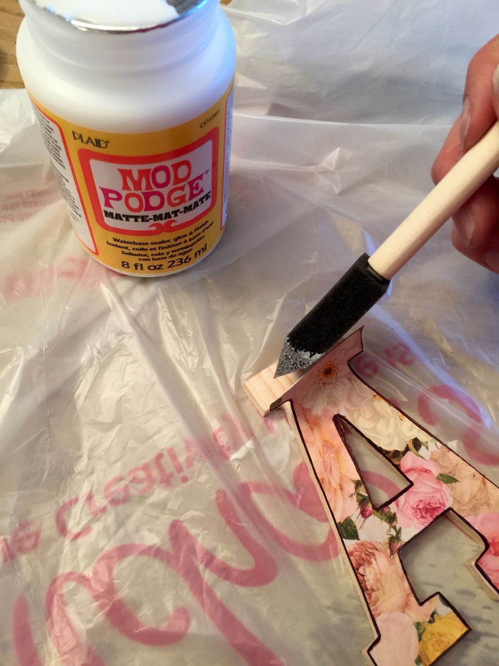 Then using mod podge glue down the paper on the wooded letter.