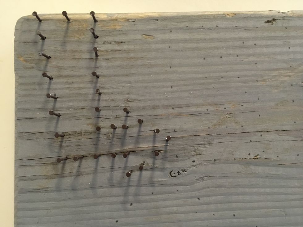 Then, using small finishing nails, put a nail in each dot. I hammered them in leaving about a 1/2" sticking out of the wood.