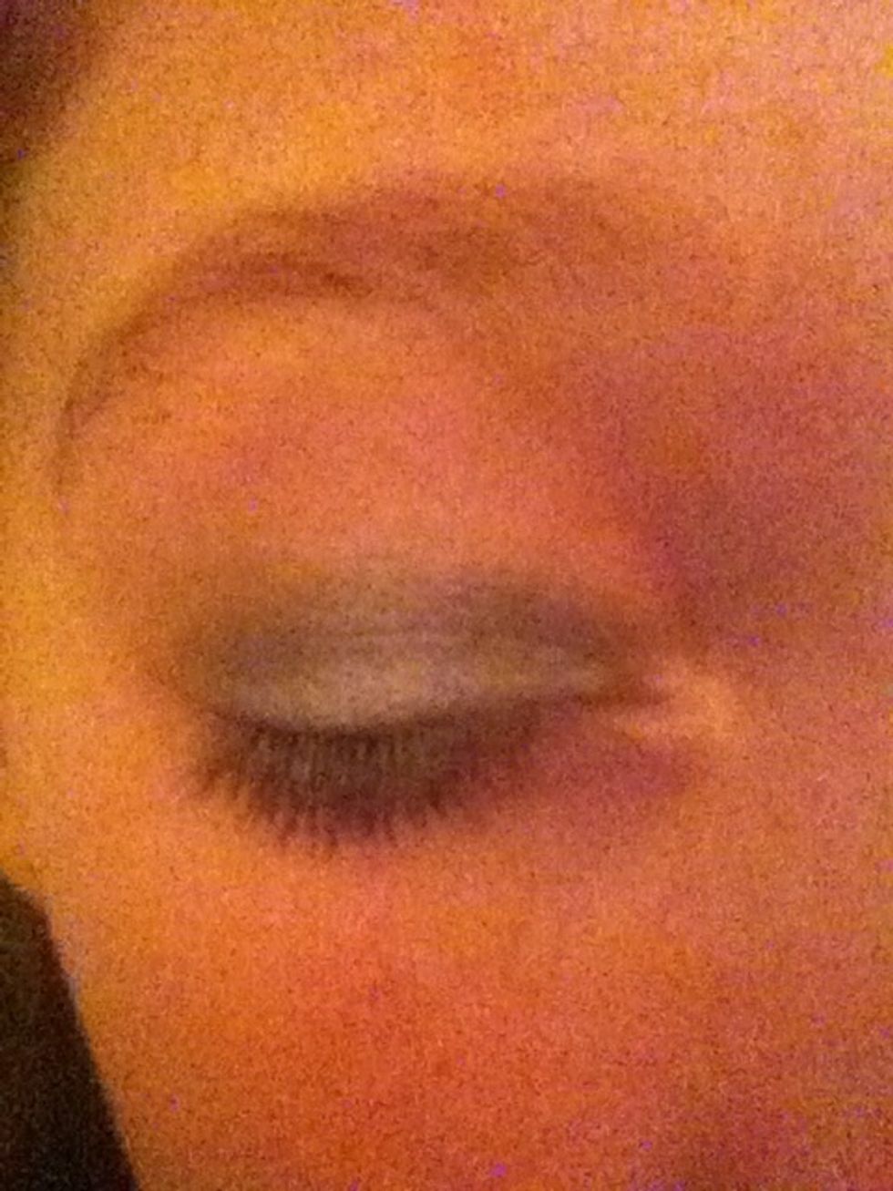 Then using the black eyeshadow and eyebrow brush, cover the eye lightly around the middle getting darker towards the crease line and socket.