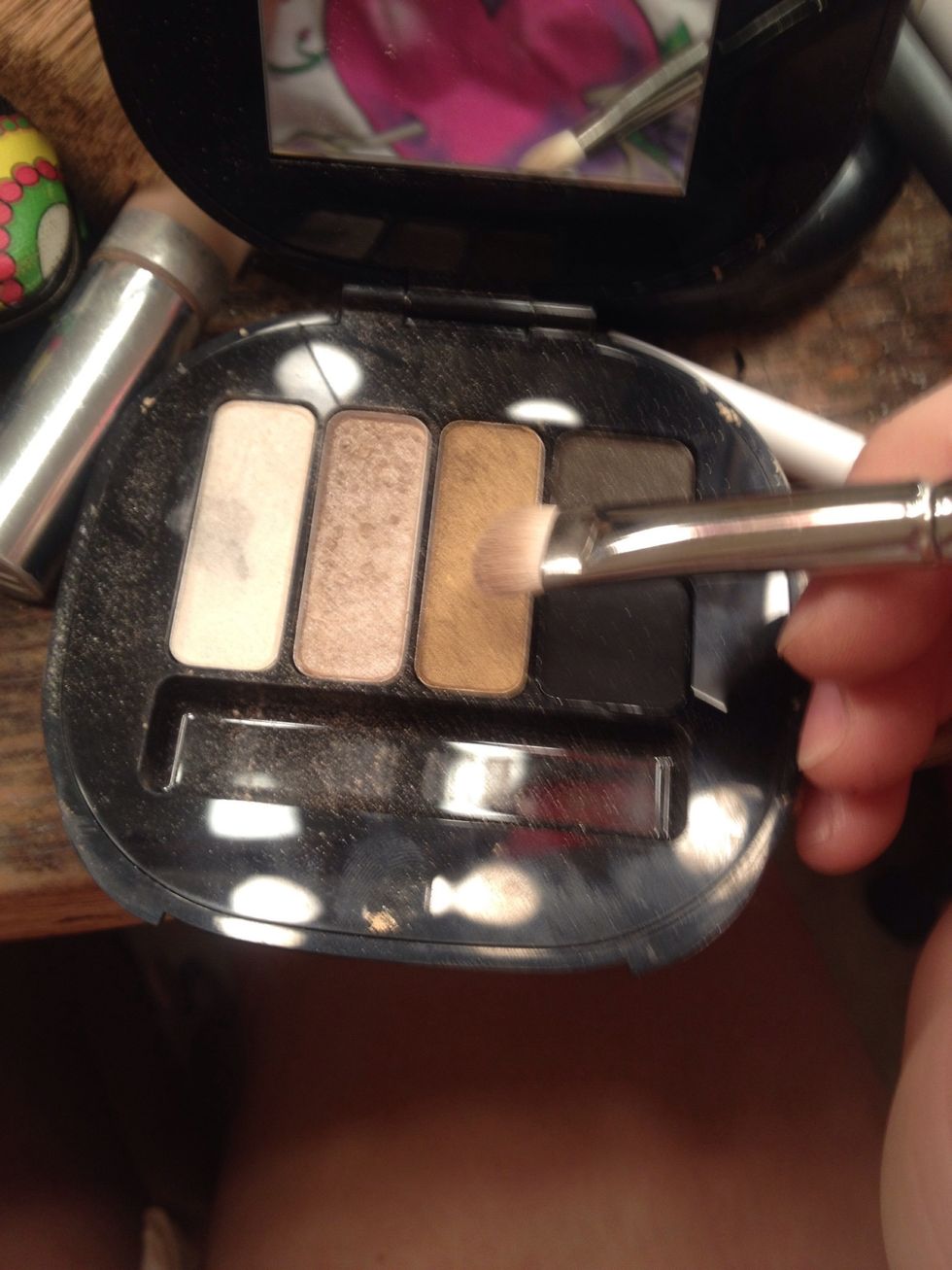 Then using the same brush use the gold shimmery color