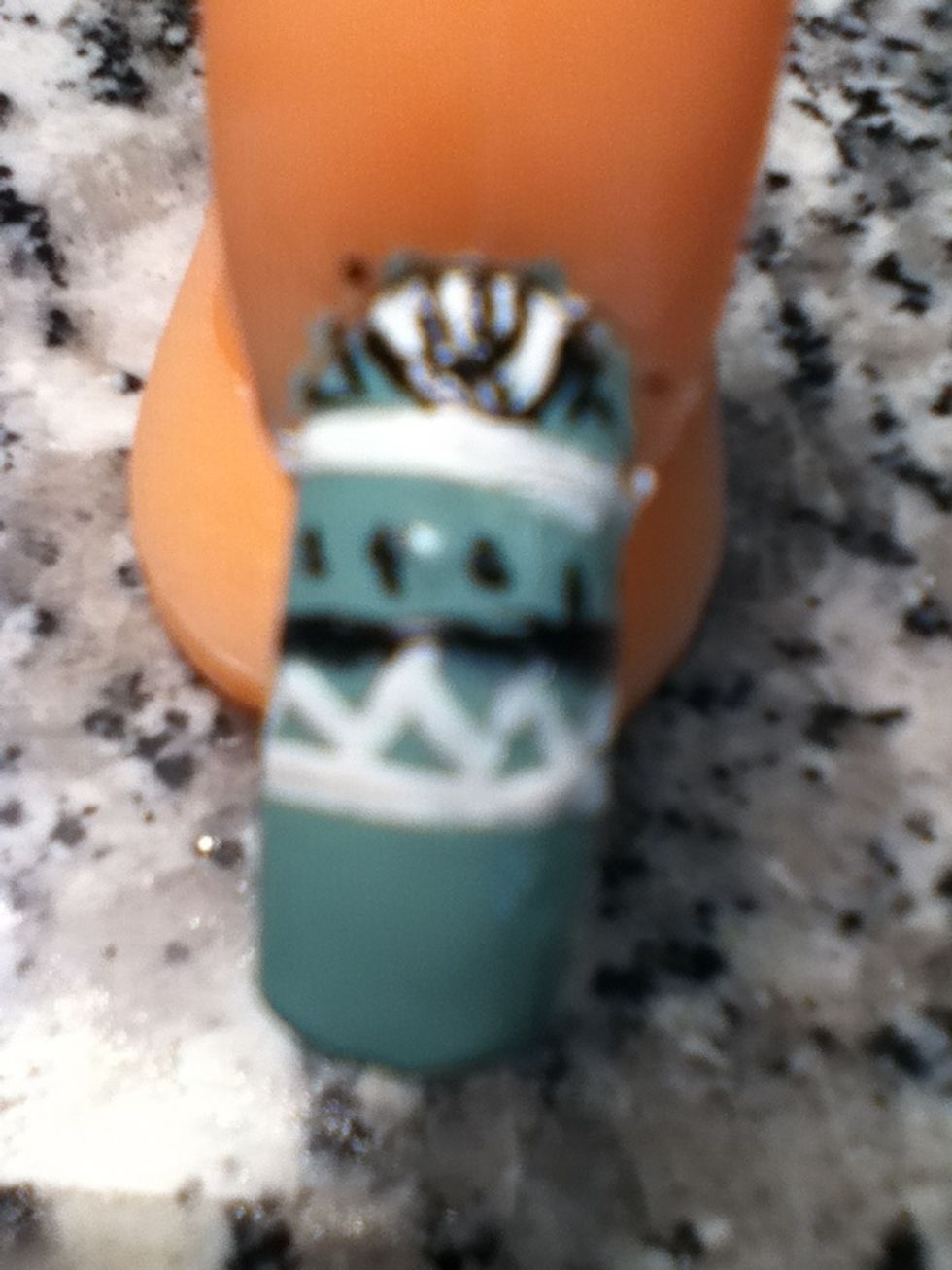 Then using the white nail polish make a zigzag in between the white and black line.