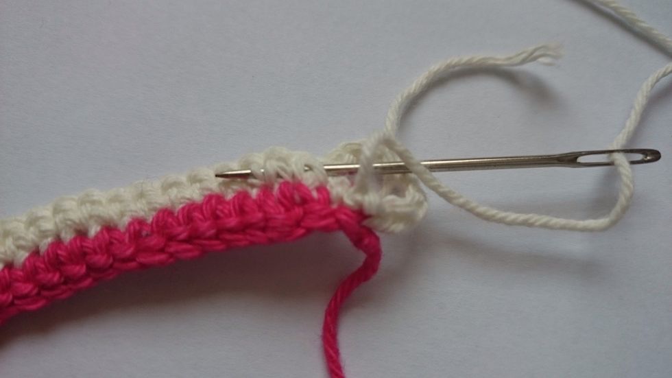 Then, using the yarn needle,weave the 'tails' through the stitches.
