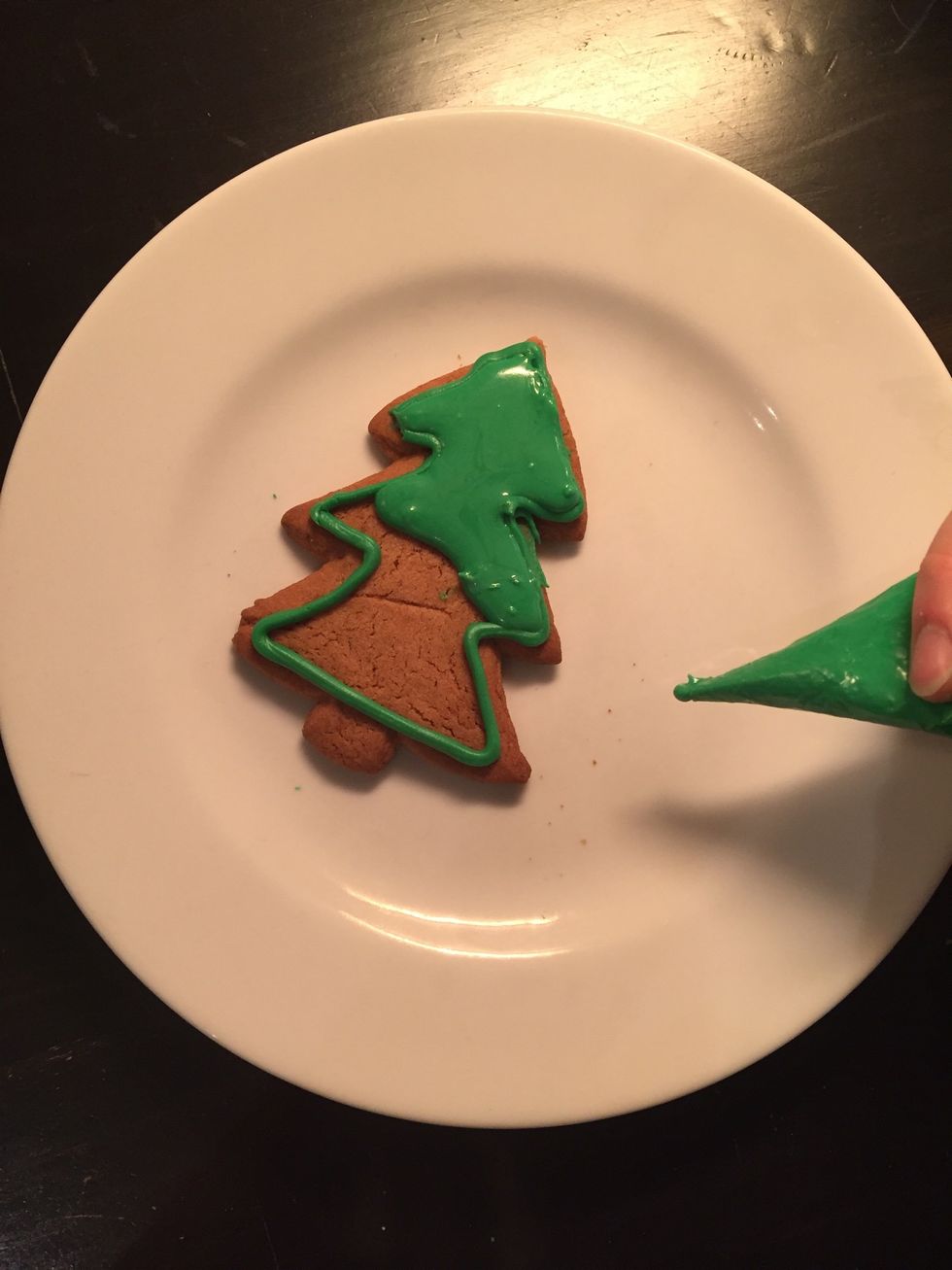 Then water down the icing, little at a time, until it flows easily, but not as thin as water. Then 'fill in' the outlined shape, making sure the icing doesn't spill over the barriers of thick icing.