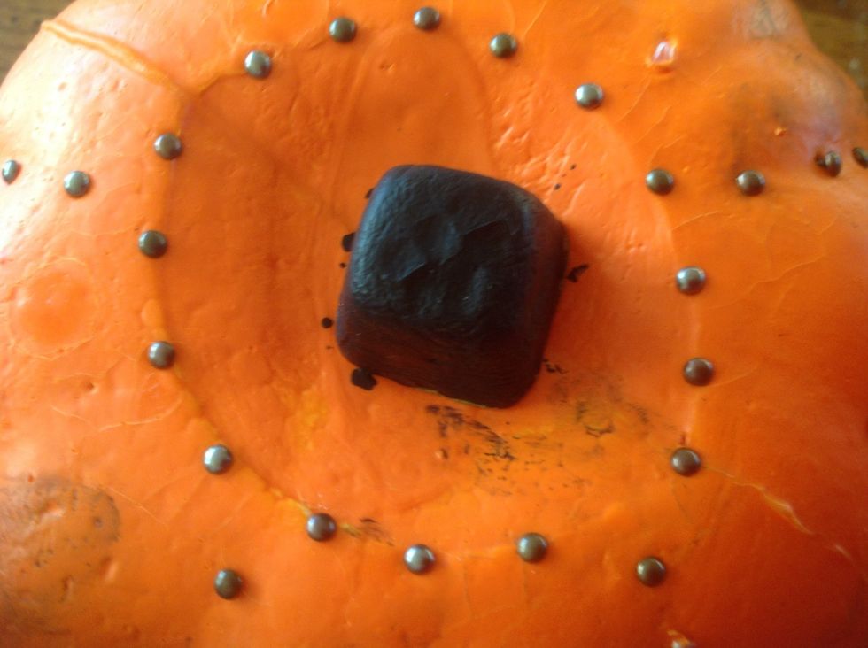 Then when u are done putting the brads in the lines of the pumpkins, get some more brads and put them in a circle surrounding the stem.