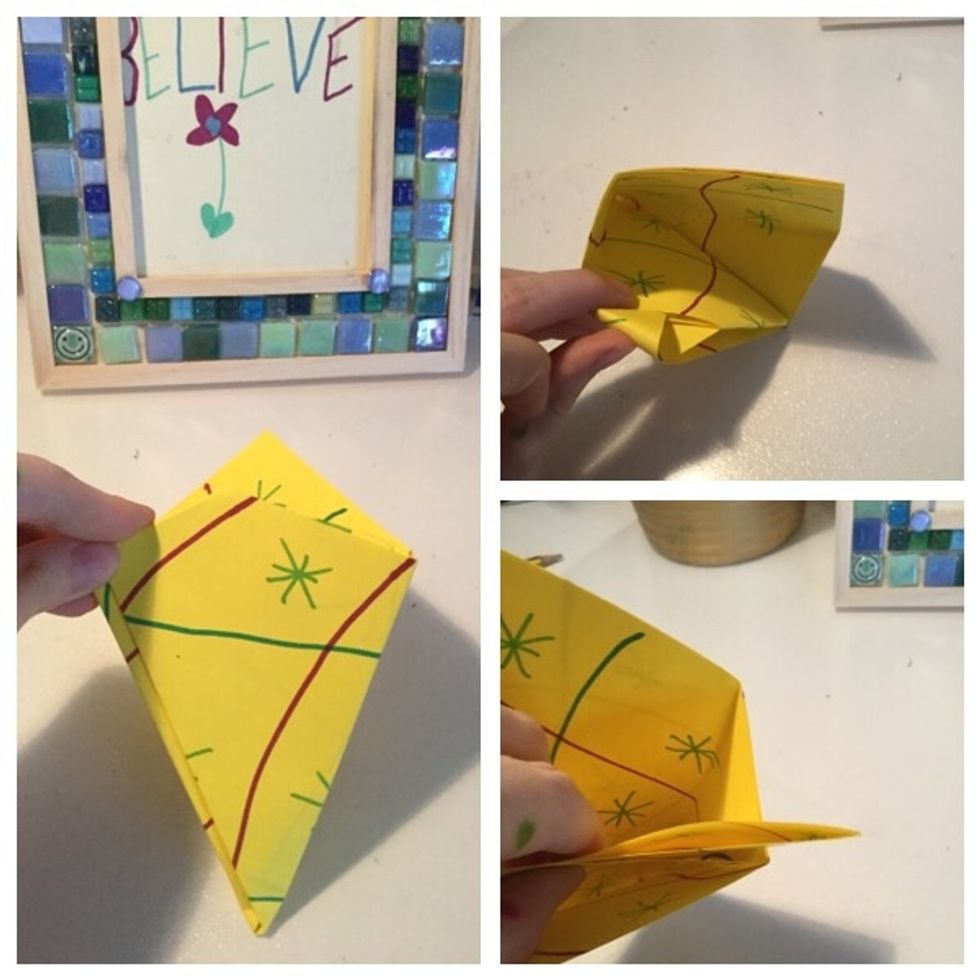 Then where the slits are in front and behind the x fold one side of the x into it. Do the same on the other side