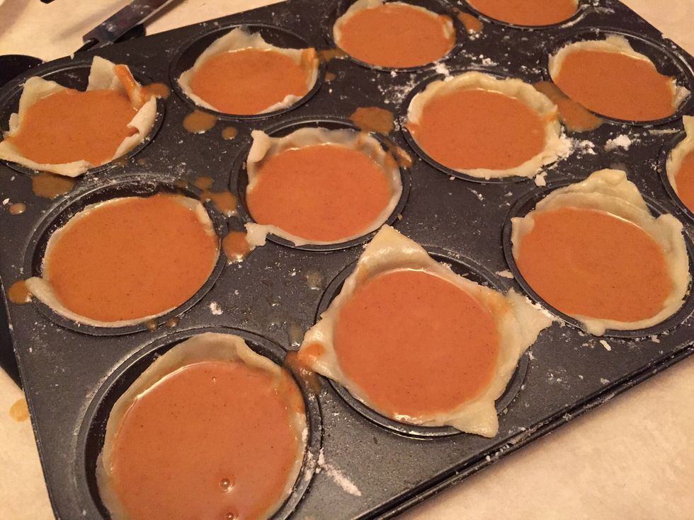 Then with a cupped spoon you can pour mixture in tray. Mixture can go a little bit under rim of dough. Then place in oven for 15 minutes at 450.