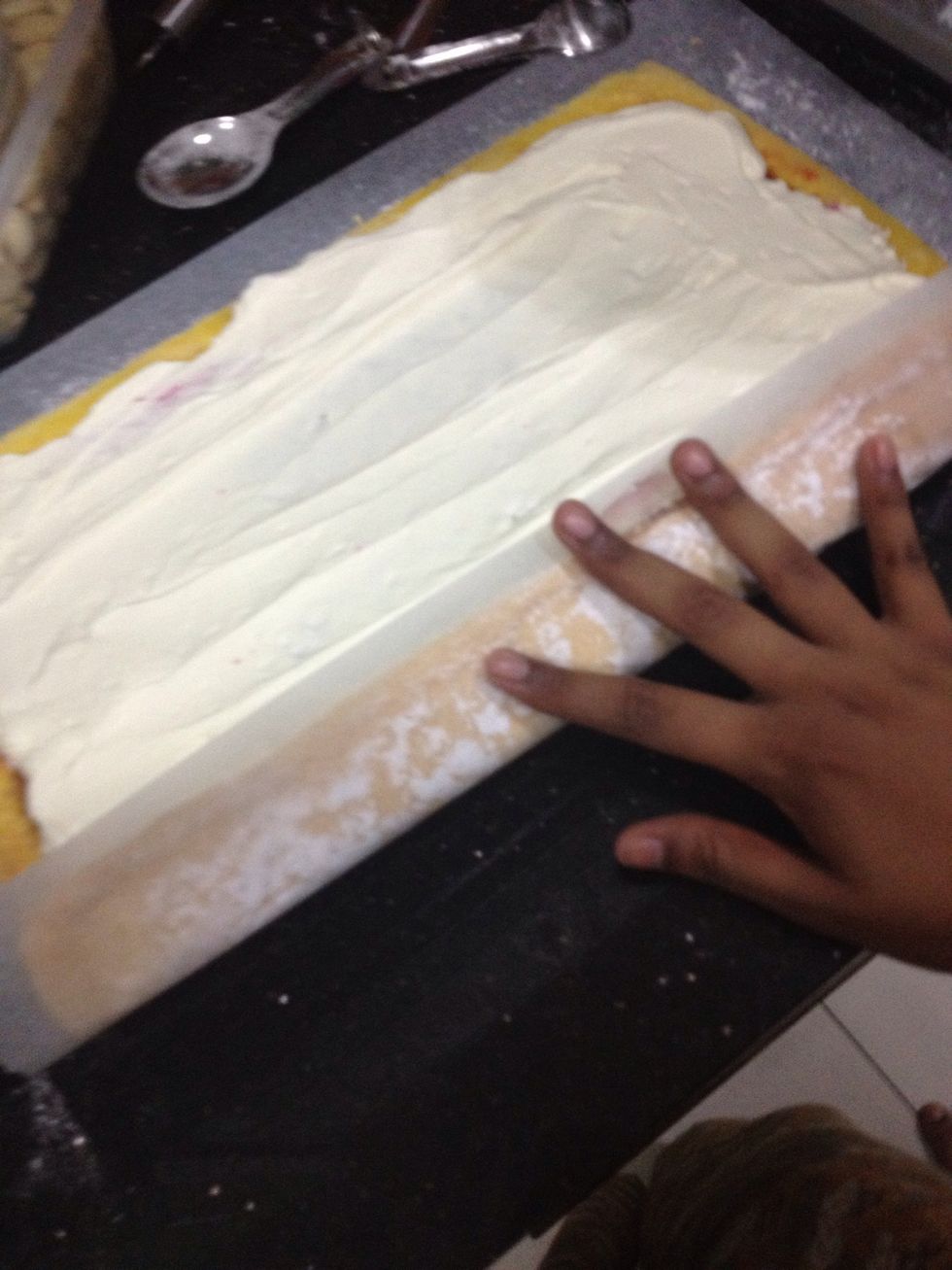 Then with the edge closest to you, roll sponge gently from long side to enclose filling.