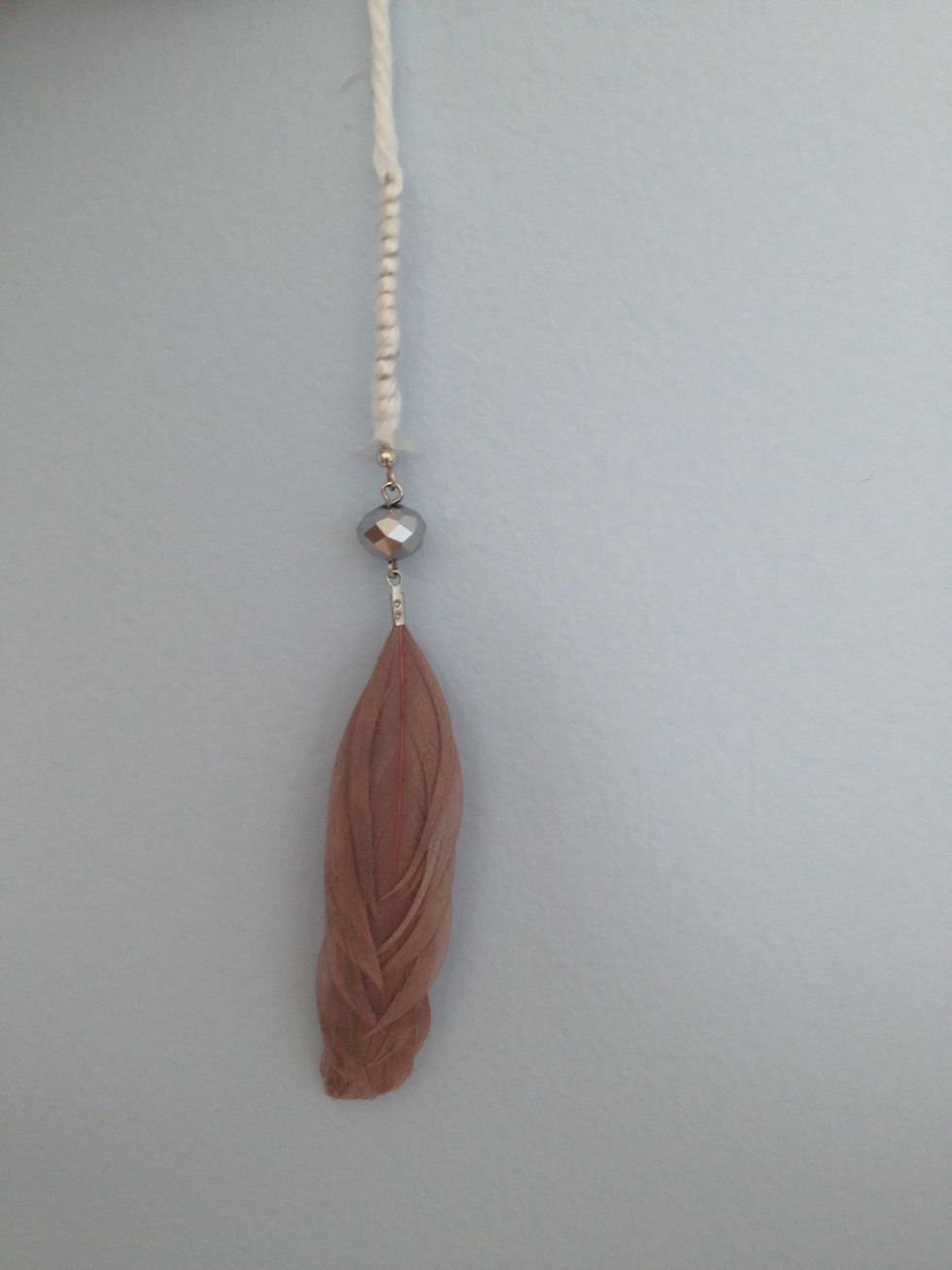 Then wrap it with string and tie it to the dream catcher. If you're using regular feathers just tie them to the dream catcher.