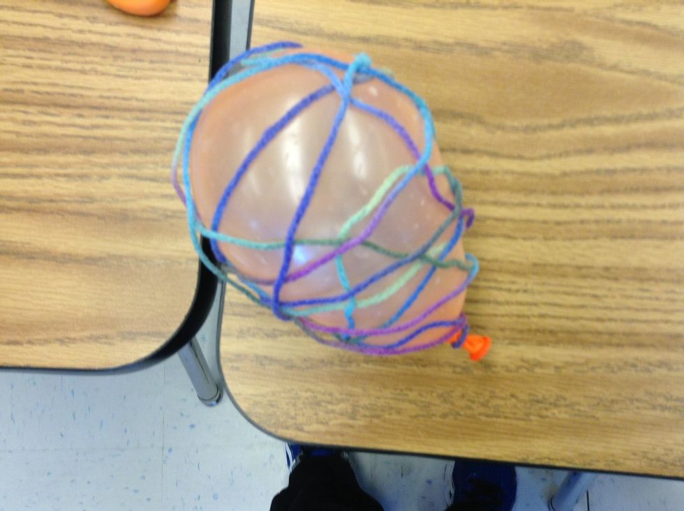 Then, wrap the glued yarn around the balloon.