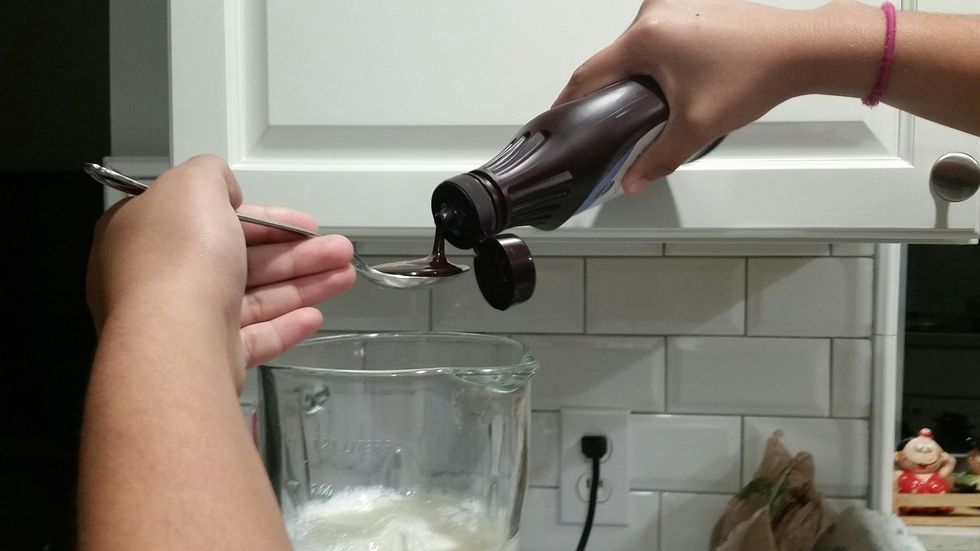 Then you add three spoons of chocolate syrup and put it in the blender