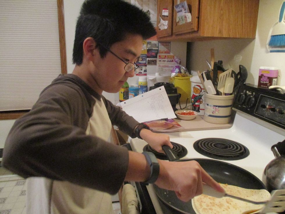 Then you flip the tortilla to see if the bottom of the tortilla is golden brown. if it's golden brown then take the quesadilla off and put it on the plate.