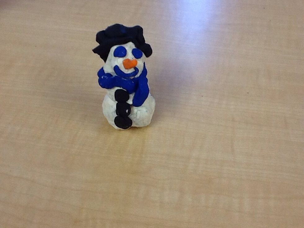 Then you get a piece of black clay and make it into a hat.