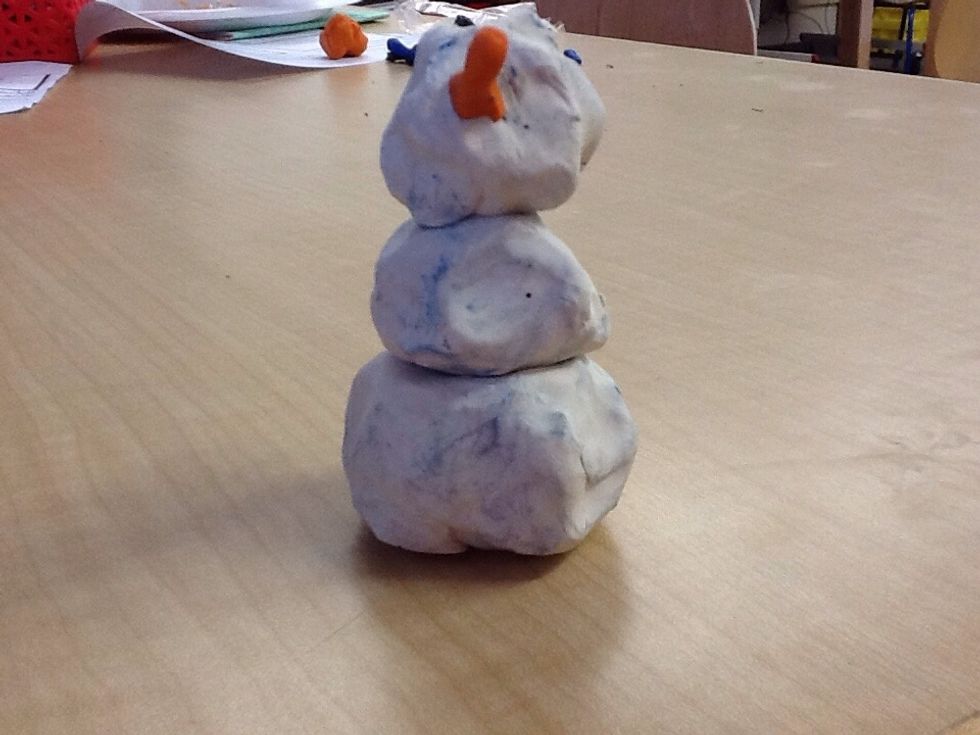 Then you get a piece of orange clay and make a snowman nose.