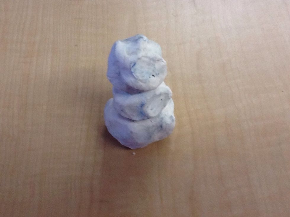 Then you get a small piece of white clay and roll it into a small ball.