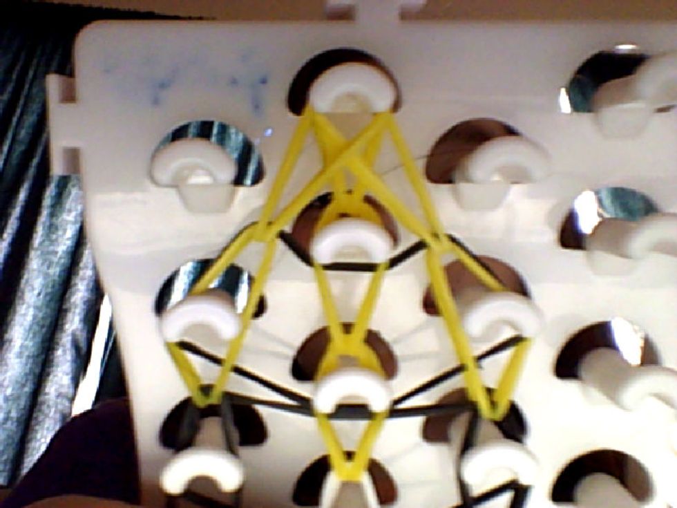 Then you grab the two sides and put it in the middle.DO NOT LET IT GO IT WILL ALL FALL APART.